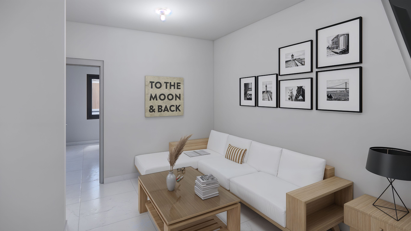 Estancia de la casa modelo Aura de la residencia angeles residencial en Chihuahua, con un sofa, mesa de cafe y fotografias en las paredes.